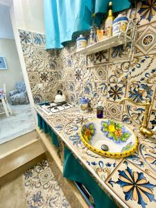 a bathroom with a counter with a sink at Ortigia Dreaming in Siracusa