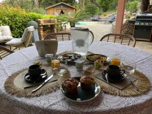 a table with plates of food on top at Carpediem corsica adult only in Poggio-dʼOletta