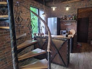 a kitchen with a wooden counter and a brick wall at odahouse. fireplace and spring water. in Batumi