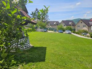 a yard with houses and a green lawn at Apartman Rakovica in Sarajevo