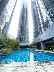 a pool in a building with two tall buildings at Eastern Suites Star KLcc in Kuala Lumpur
