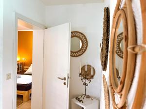 a hallway with a mirror and a room with a bed at Teichapartment in Michelbach an der Bilz