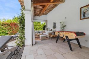 a living room with a pool table and a couch at Villa Madiana - "Le Diamant" climatisée, piscine privée chaufffée, Fitness,proche Cannes, Grasse in Montauroux