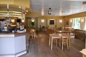 a dining room with tables and chairs in a restaurant at Het vlindertje in Durbuy