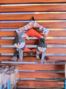 two stuffed animals are sitting on a wooden bench at Chalés Lanelli in Monte Verde