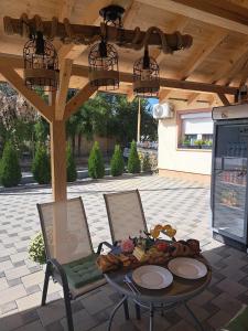a patio with a table and chairs under a pergola at Villa Ristovski in Ohrid