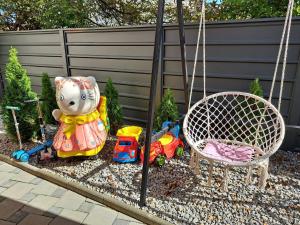 a garden with toys and a swing and a stuffed animal at Villa Ristovski in Ohrid