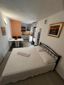 Un dormitorio con una cama grande y una cocina. en Apartments Denis, en Supetar