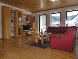 a living room with a red couch and a table at Gästehaus Bleser in Ernst +50 photos