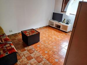 a living room with a tiled floor and a tv at Villa Tamadaba Rural Home - Good WiFi, Pet Friendly, 5-min Drive to Beach in Agaete