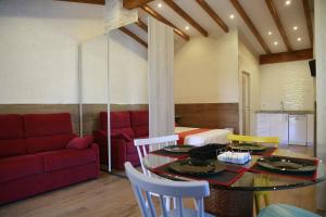 a living room with a table and a red couch at Apartamentos La Arena in Miengo