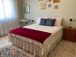 a bedroom with a large bed with blue pillows at Casa Gori in Montecatini Terme