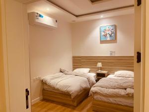 two beds in a small room with a bed sidx sidx sidx at بيتي بلس للغرف الفندقية- مدخل مستقل in Riyadh Al Khabra