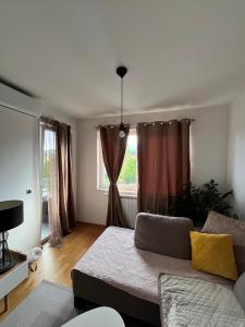 a living room with a couch and a window at NewFormula in Sarajevo