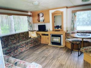 an rv living room with a couch and a desk at Namelis Pušų pakrašty in Palanga