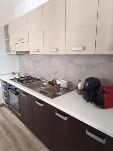 a kitchen with a stove and a counter top at Appartamento Azzurra in Melendugno