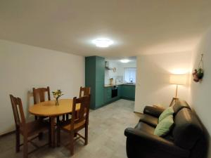 a living room with a couch and a table and a dining room at Marie-Thérèse in Manspach +14 photos
