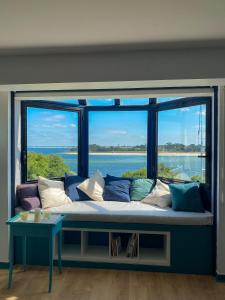 a couch in a room with a large window at La Vigie perchée - Les Gîtes de la Côte d'Amour in Le Croisic