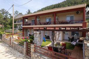 a house with a balcony with a table and chairs at Antigone View Apartments in Skala Potamias
