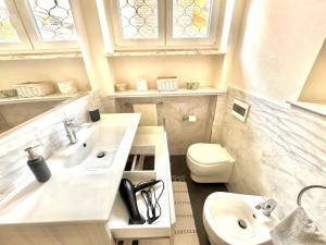 a bathroom with a sink and a toilet at Villa Matteotti Garden Lux 200mt by the sea in Forte dei Marmi +21 photos