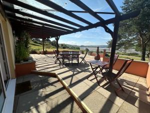 a patio with a table and chairs on a house at Sheko Annex in Cardigan +8 photos