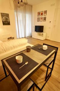 a living room with a table and a couch at A casa di Sara in Ostia Antica +38 photos