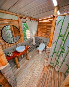 a bathroom with a sink and a toilet in a room at Santuario Deluxe in Trujillo