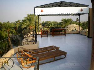 a balcony with two benches and a table at Nile Dream Apartments in Luxor +6 photos
