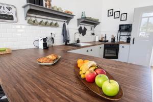 a wooden table with fruit on it in a kitchen at Treize Maison A - 3 bed house in centre of Saint Severin in Saint-Séverin +18 photos