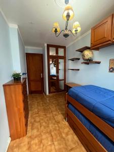 a bedroom with a blue bed and a wooden cabinet at Saltflat2, be surrounded by sun, water and peace in Los Cancajos +63 photos