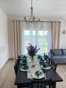 a dining room with a black table and chairs at Vila Trakai in Trakai