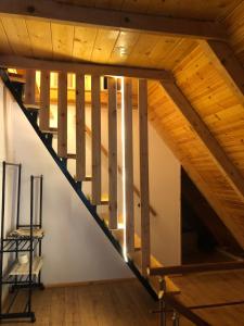 a staircase in a loft with wooden ceilings at Cold Springs in Theth