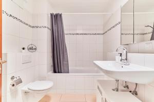 a white bathroom with a sink and a toilet at Traumferienwohnung Domblick - Parkplatz inklusive, zentral mit Altstadtblick & Netflix in Limburg an der Lahn +23 photos