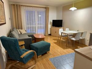 a living room with a couch and a table at Apartman Kamila in Janske Lazne