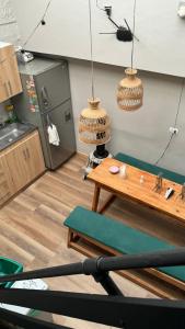 a kitchen with a table and two hanging baskets at Luum Guest House Manila in Medellín