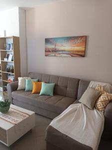 a living room with a couch and a table at Igli apartments in Arkasa