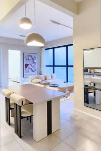 a kitchen and living room with a table and chairs at Tatami with HomeCinema, 9pax, Urban Suites by PG Home in George Town