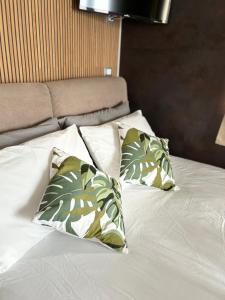 a bed with two pillows on top of it at Viva Suitesboat in Marina di Montenero +12 photos