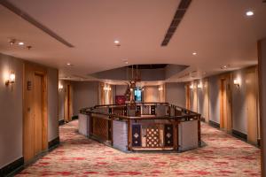 a large hallway with a lobby with a large rug at Hotel Pokhara Grande in Pokhara