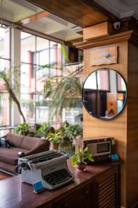 a desk with a printer and a mirror on it at Hotel Pokhara Grande in Pokhara