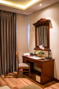 an office with a desk with a mirror and a chair at Hotel Pokhara Grande in Pokhara +36 photos