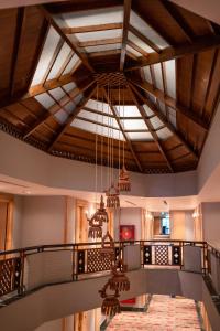 a large room with a staircase with a chandelier at Hotel Pokhara Grande in Pokhara