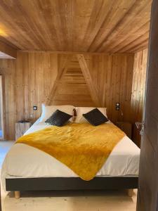 a bedroom with a large bed with a wooden ceiling at L'Appartement de Maman, Jacuzzi & Hammam privé in La Bresse +77 photos