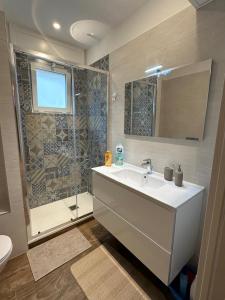 a bathroom with a sink and a shower at Rainbow Luxury Home Bari in Bari +42 photos