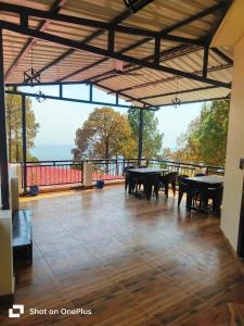 a large patio with tables and a view of the ocean at Monarch Hills in Lansdowne