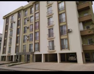 a large white building with balconies on the side of it at Lake View Apartment in Famagusta in Mağusa