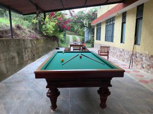a pool table with a ball on it in a courtyard at Finca San Jerónimo in Arbeláez