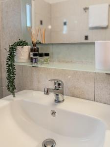 a bathroom sink with a faucet on top of it at LefCoast SENSUS Apartments in Paralía Avdhíron +22 photos