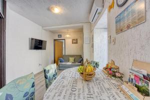 a dining room table with a basket of bananas on it at Apartments Cindrić in Selce