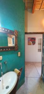 a bathroom with a sink and a green wall at Casa La Molina in Tilcara +41 photos
